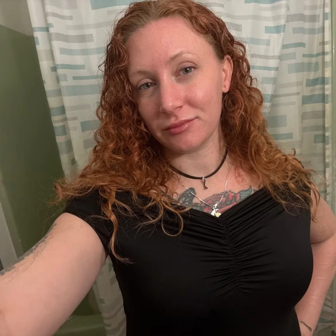 Maddy in a black top with moon necklaces